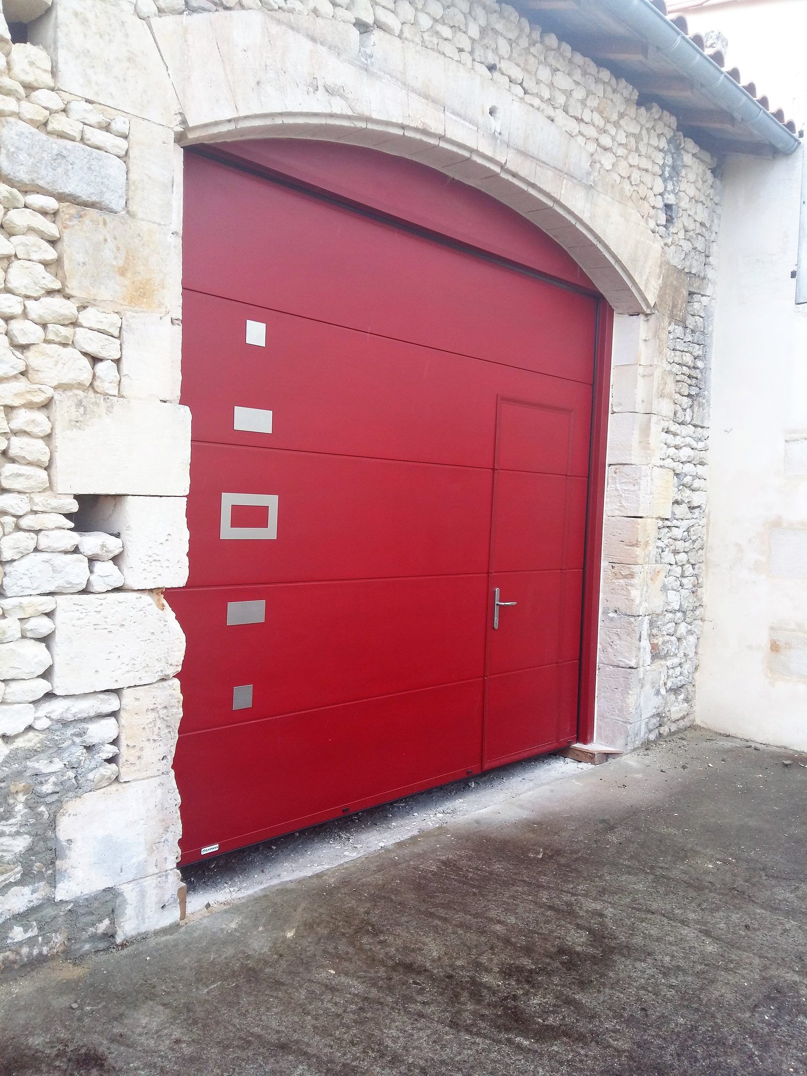 Porte de garage sectionnelle rouge à inserts inox — Pays jonzacais